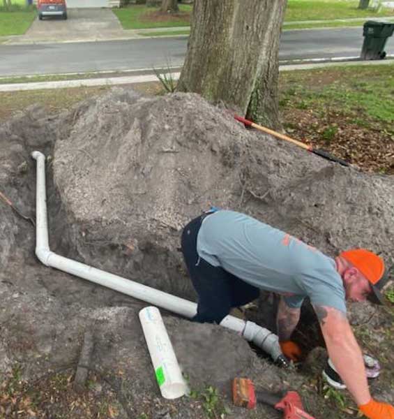 Plumber from All Hours Plumber replacing a 4" PVC sewer line in the front yard of a Tampa home
