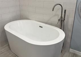 Stand-alone tub and floor mounted tub filler installed in a home in Temple Terrace, FL