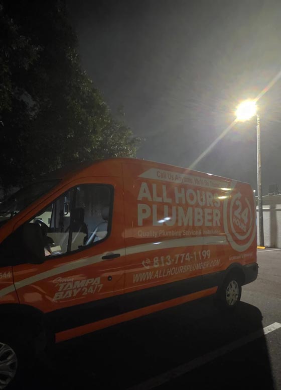 All Hours Plumber under a street light at night at an emergency plumbing call in the middle of the night.