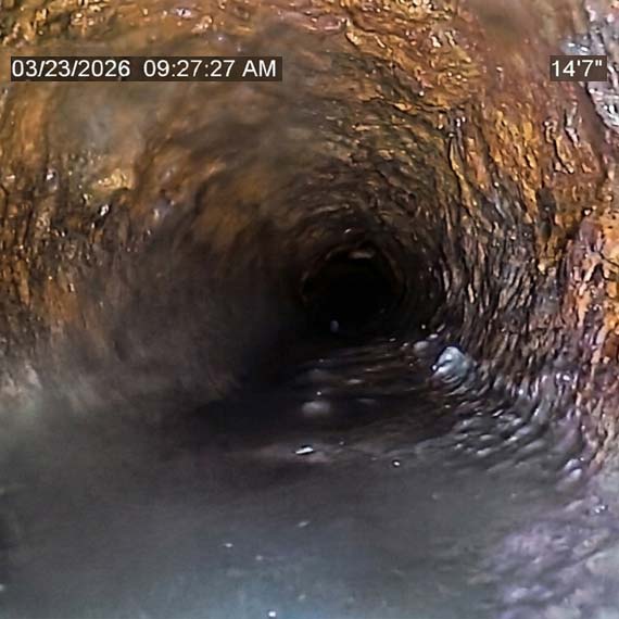 VIDEO CAMERA INSPECTION ON THE INSIDE OF AN AGING CAST IRON PIPE SHOWING LARGE AMOUNTS OF SCALE AND DAMAGE